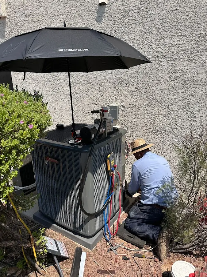 HVAC technician performing outdoor AC maintenance in Pleasant Hills